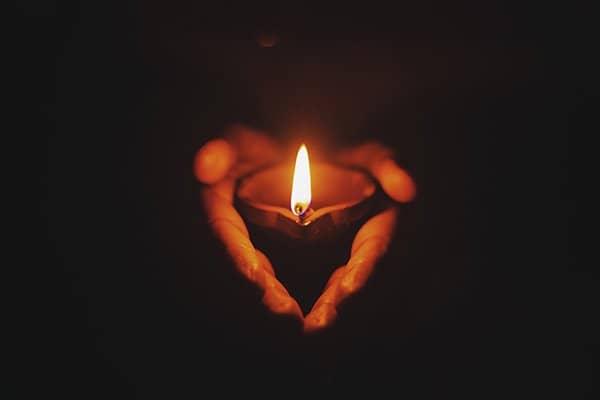 man holding candle | death forward