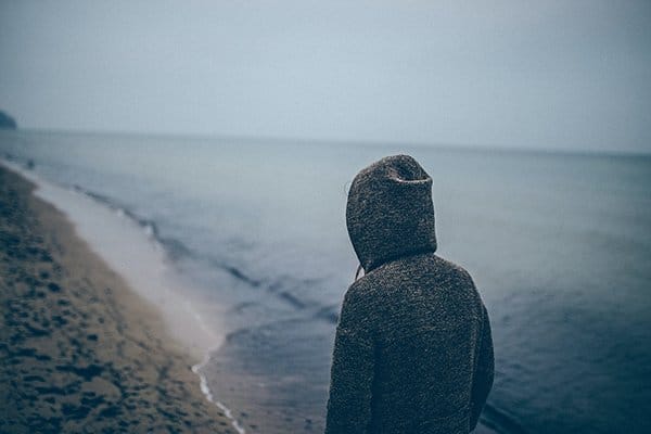resentment | man standing at beach