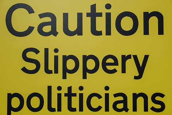 politicians hate you | sign that says caution slippery politicians