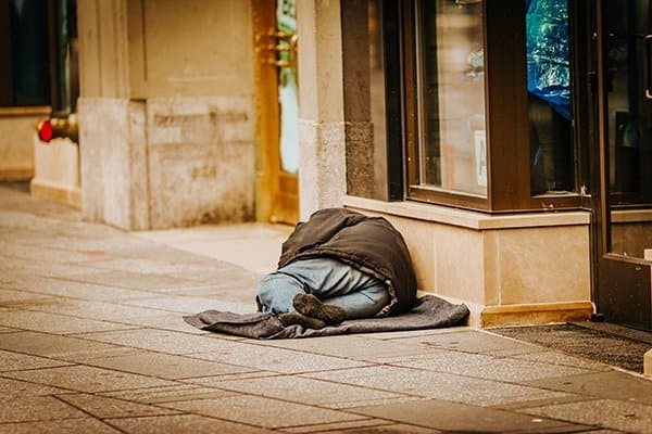 homelessness | homeless man on the sidewalk