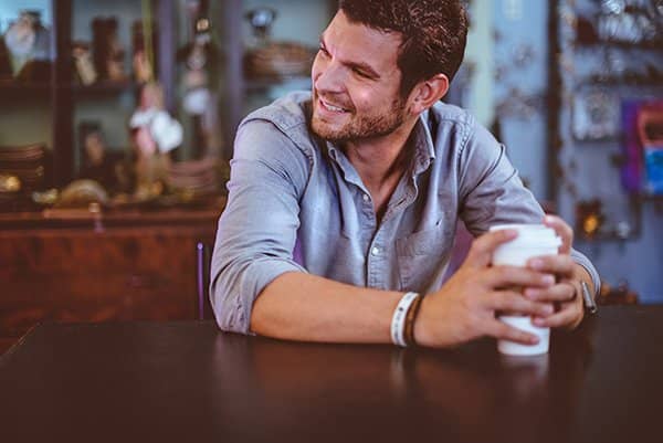 happy | man holding coffee cup and smiling