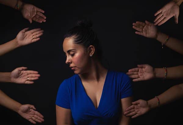 not a slave | sad woman surrounded by hands 
