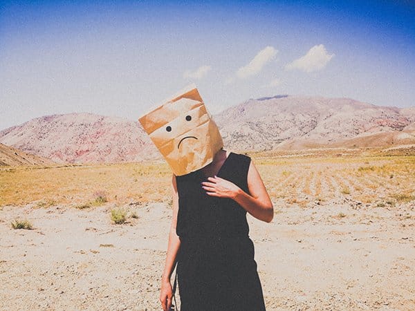 broken person | woman in desert with bag over head