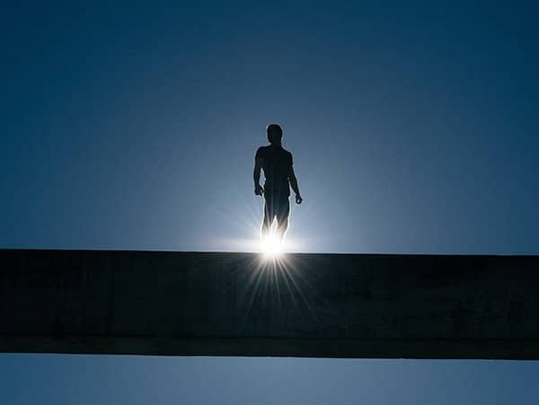 hero | man standing before the sun